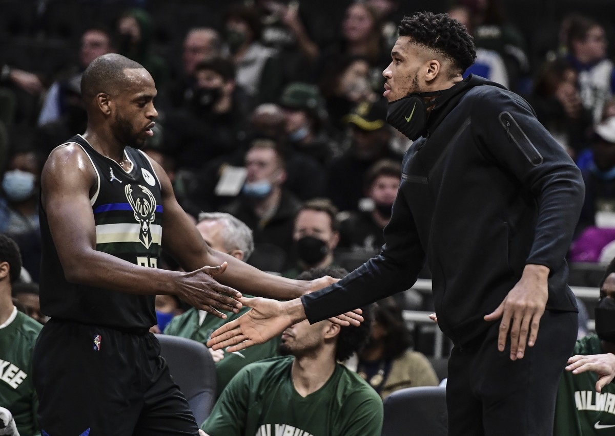 Milwaukee Bucks forward Giannis Antetokounmpo (right) reacts with forward Khris Middleton (22) 
